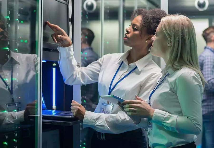 two women working on a computer server